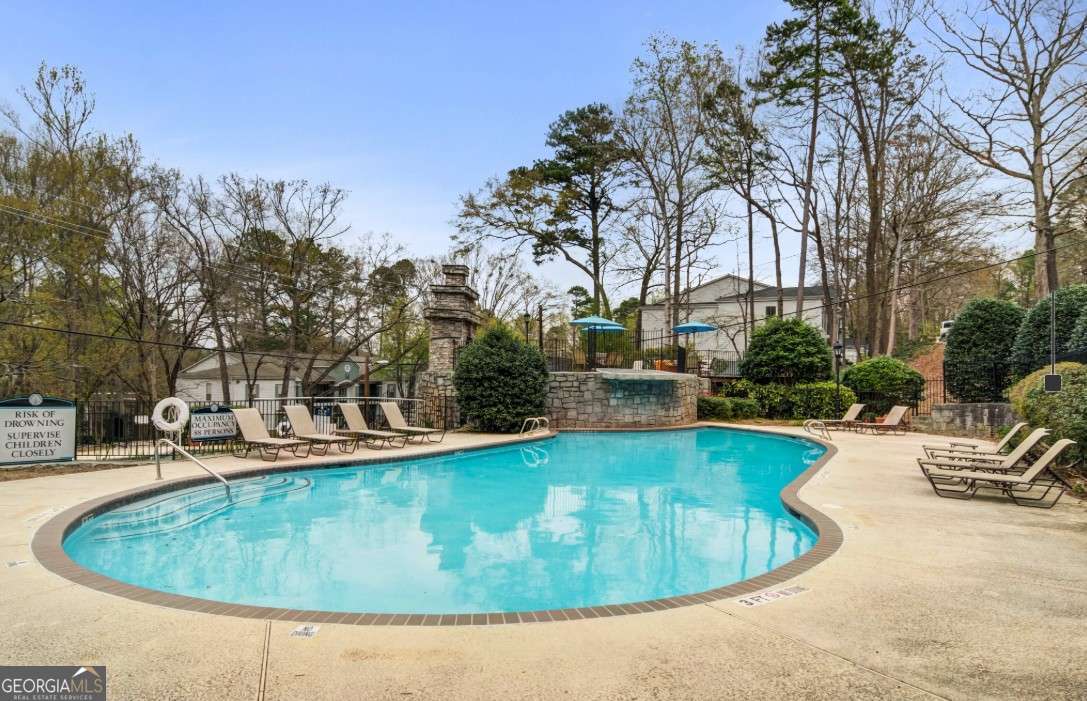 2383 Akers Mill Road Southeast, Unit L01 Atlanta, GA 30339 - Photo 12 of 30 a view of a swimming pool with outdoor seating