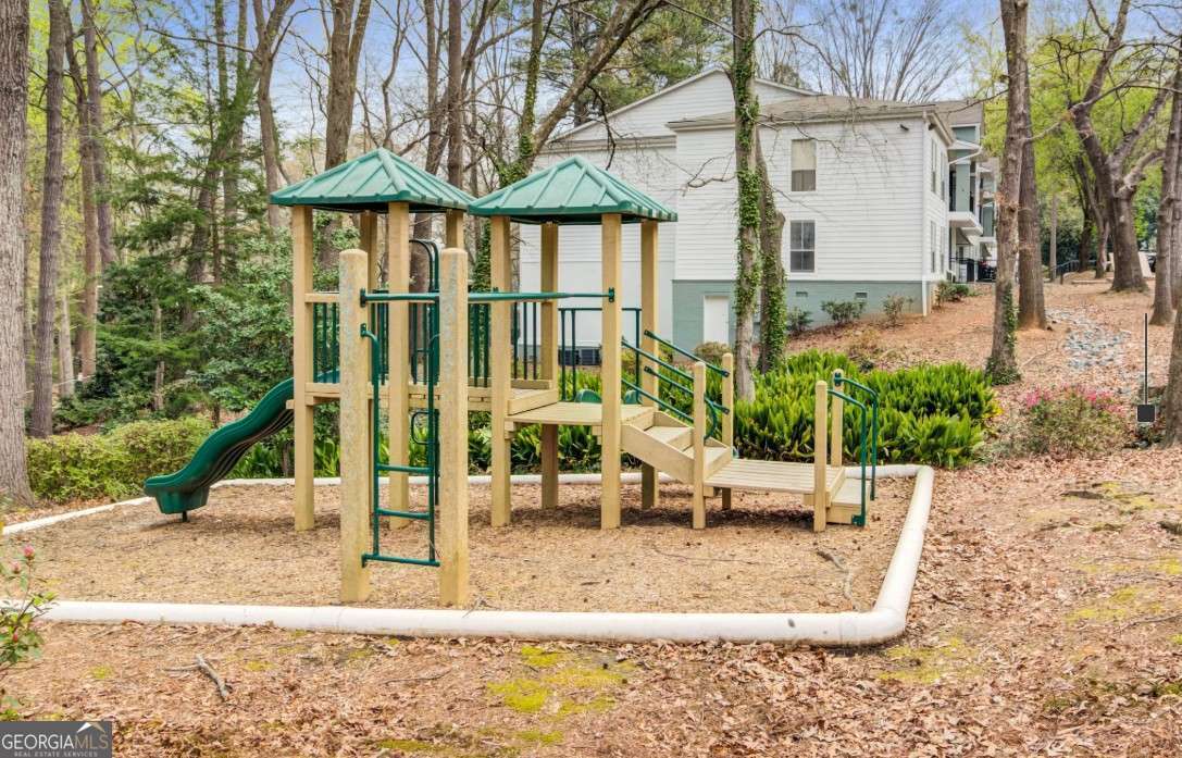 2383 Akers Mill Road Southeast, Unit L01 Atlanta, GA 30339 - Photo 21 of 30 a view of a house with backyard and sitting area
