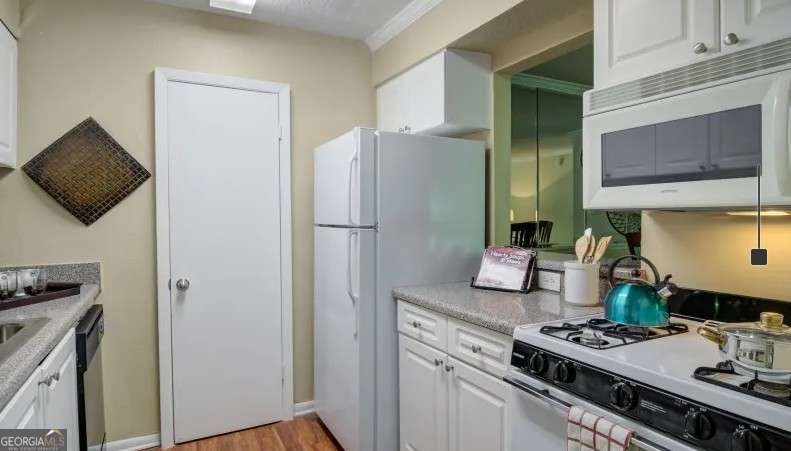 2383 Akers Mill Road Southeast, Unit L01 Atlanta, GA 30339 - Photo 24 of 30 a kitchen with stainless steel appliances granite countertop a refrigerator and a stove