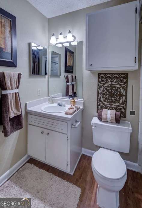 2383 Akers Mill Road Southeast, Unit L01 Atlanta, GA 30339 - Photo 28 of 30 a bathroom with a toilet sink and mirror