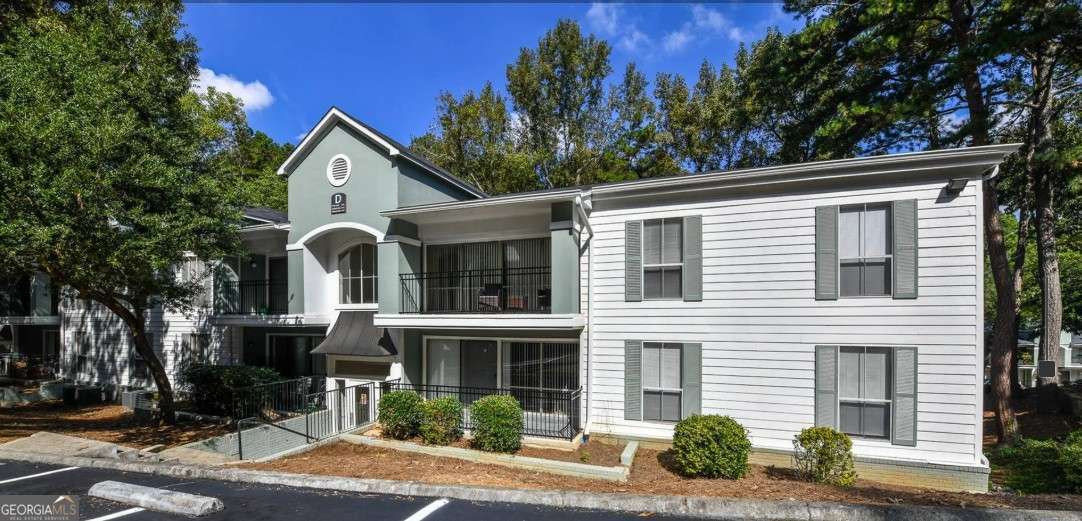 2383 Akers Mill Road Southeast, Unit L01 Atlanta, GA 30339 - Photo 30 of 30 a front view of a house with garden