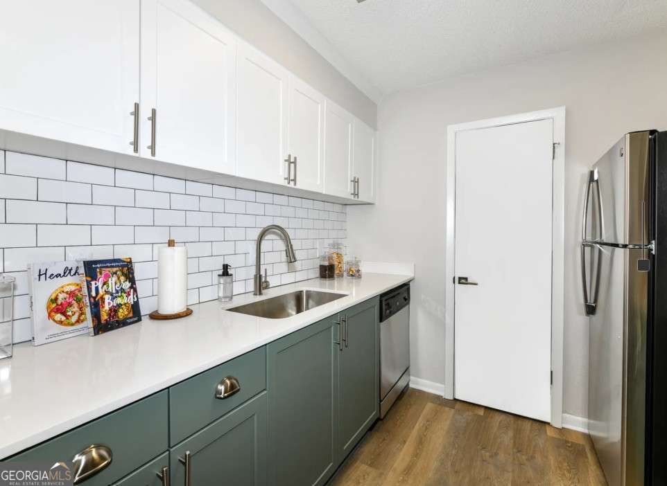 2383 Akers Mill Road Southeast, Unit L01 Atlanta, GA 30339 - Photo 4 of 30 a kitchen with stainless steel appliances a sink and a refrigerator