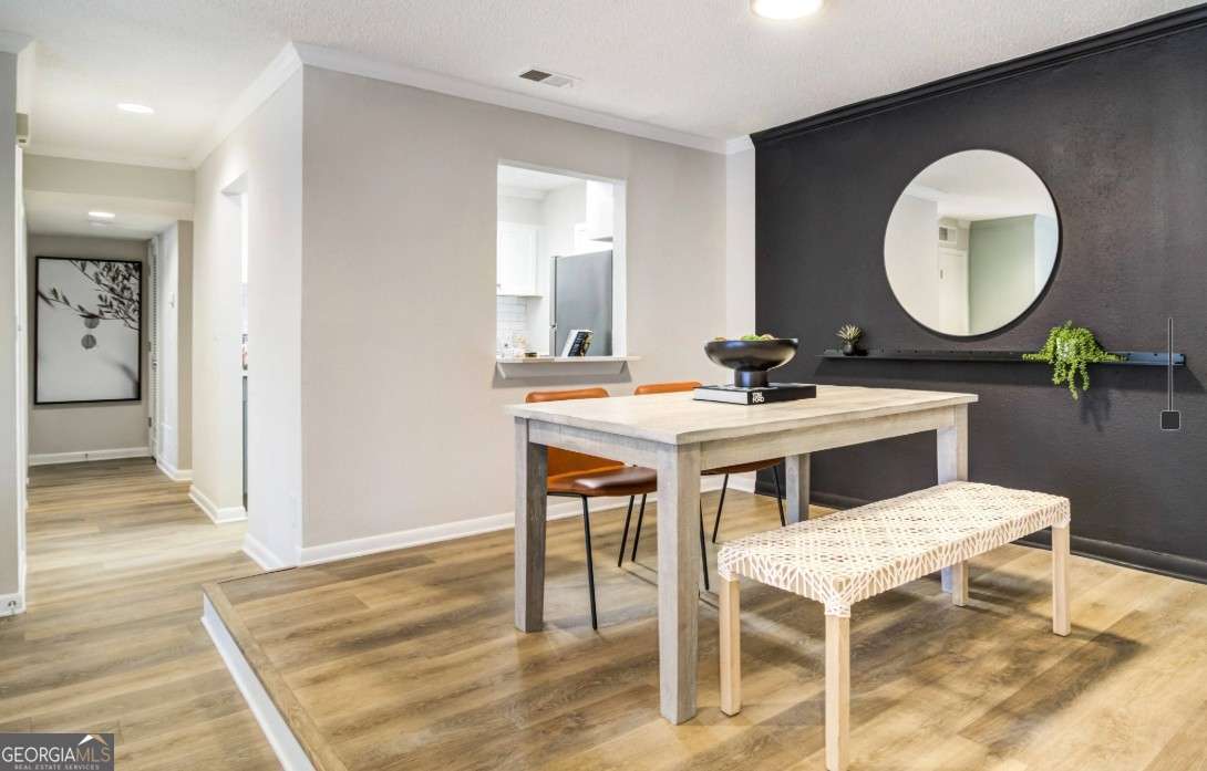 2383 Akers Mill Road Southeast, Unit L01 Atlanta, GA 30339 - Photo 6 of 30 a kitchen with a table and chairs in it