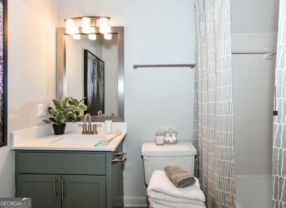 2383 Akers Mill Road Southeast, Unit L01 Atlanta, GA 30339 - Photo 10 of 30 a bathroom with a sink a toilet and shower