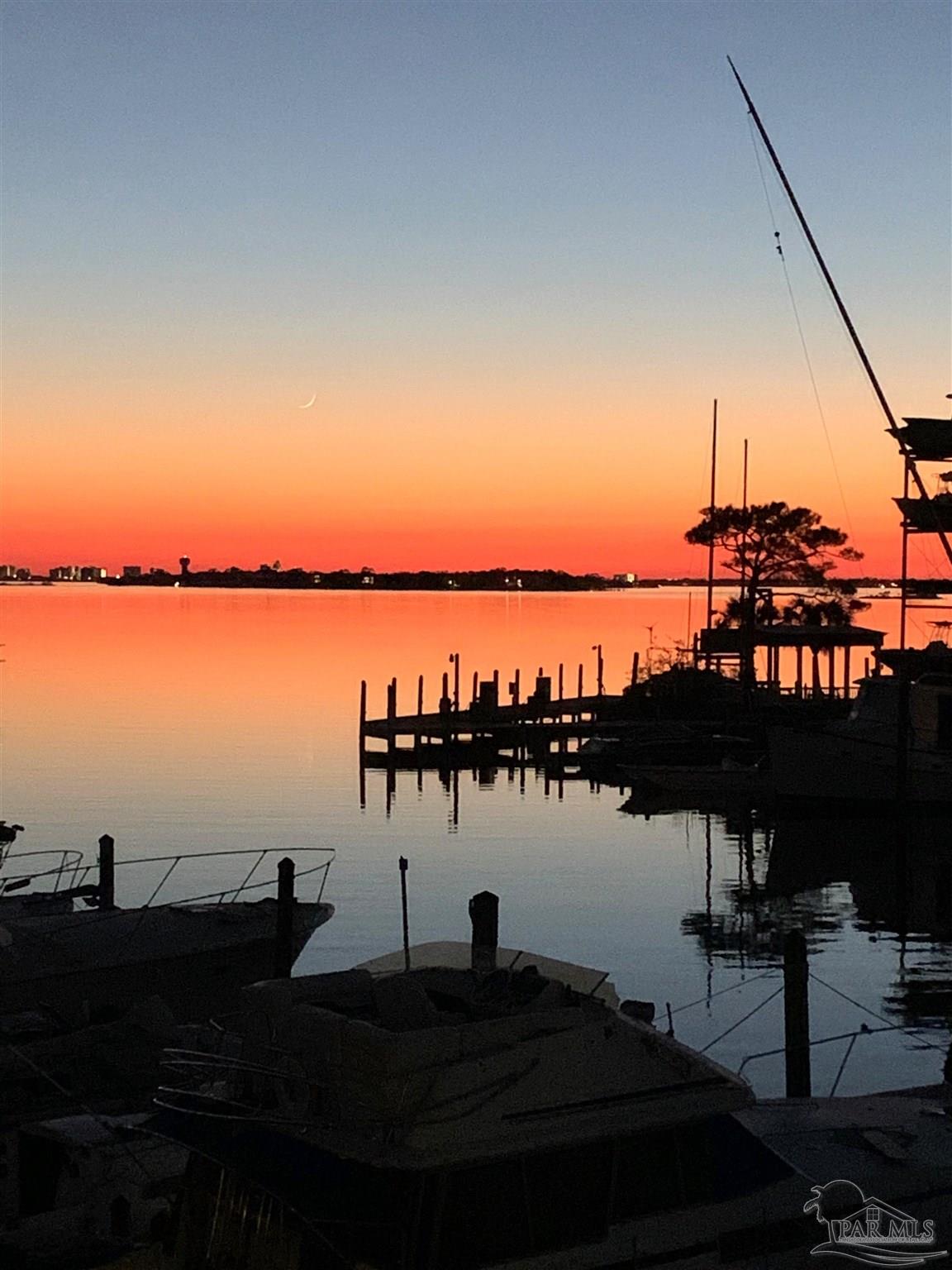 14100 River Road, Unit 228B Pensacola, FL 32507 - Photo 41 of 41 a ocean view with boats and trees in the background