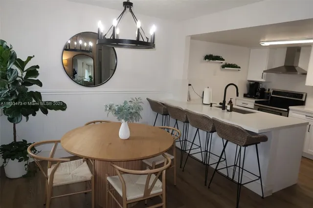 a dining room with furniture and chandelier