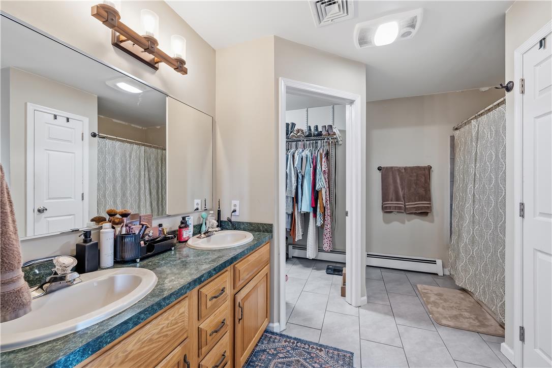 9868 Stagecoach Road Kempton, PA 19529 - Photo 10 of 17 A well-appointed bathroom with a double vanity and ample mirror space, complemented by neutral tones.