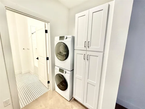 a view of a hallway with washer and dryer