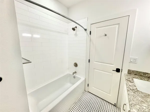 a bathroom with a bathtub and a shower