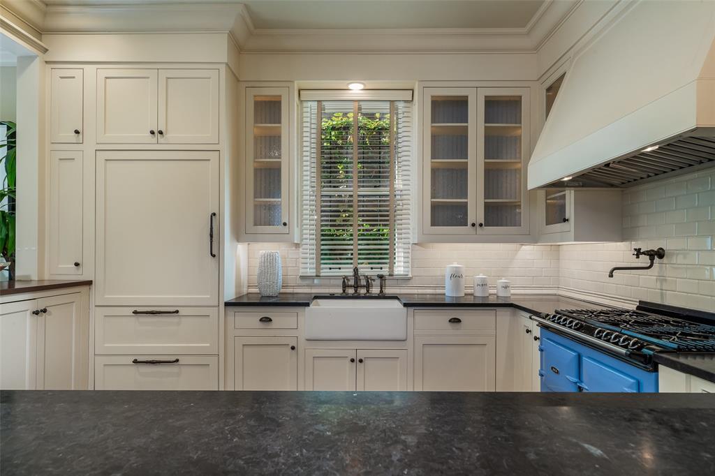 2315 Routh Street Dallas, TX 75201 - Photo 13 of 38 a kitchen with granite countertop a sink stove and cabinets