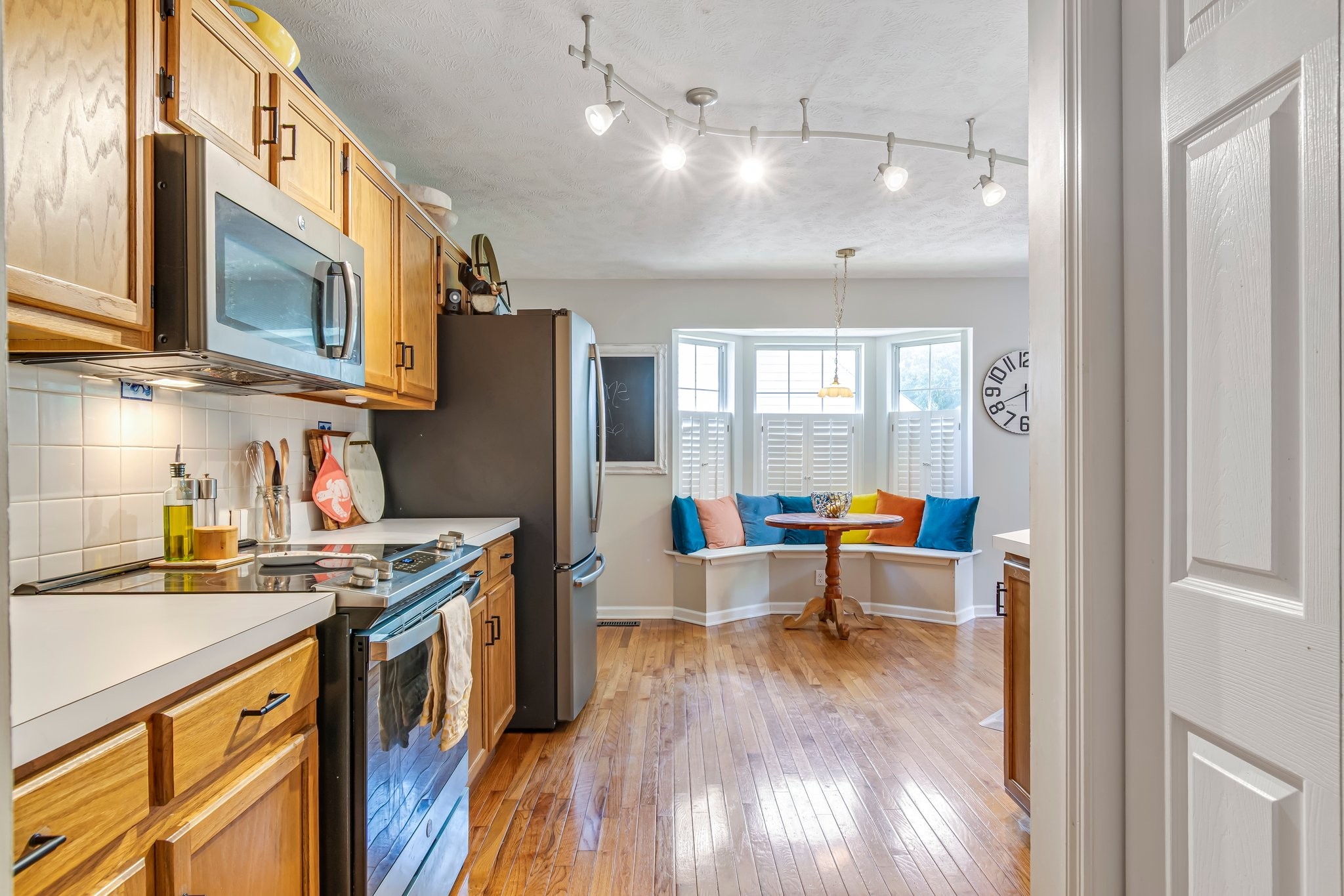 1817 Bryce Circle Nashville, TN 37211 - Photo 13 of 54 a kitchen with stainless steel appliances granite countertop a refrigerator a sink dishwasher a stove and a dining table with wooden floor