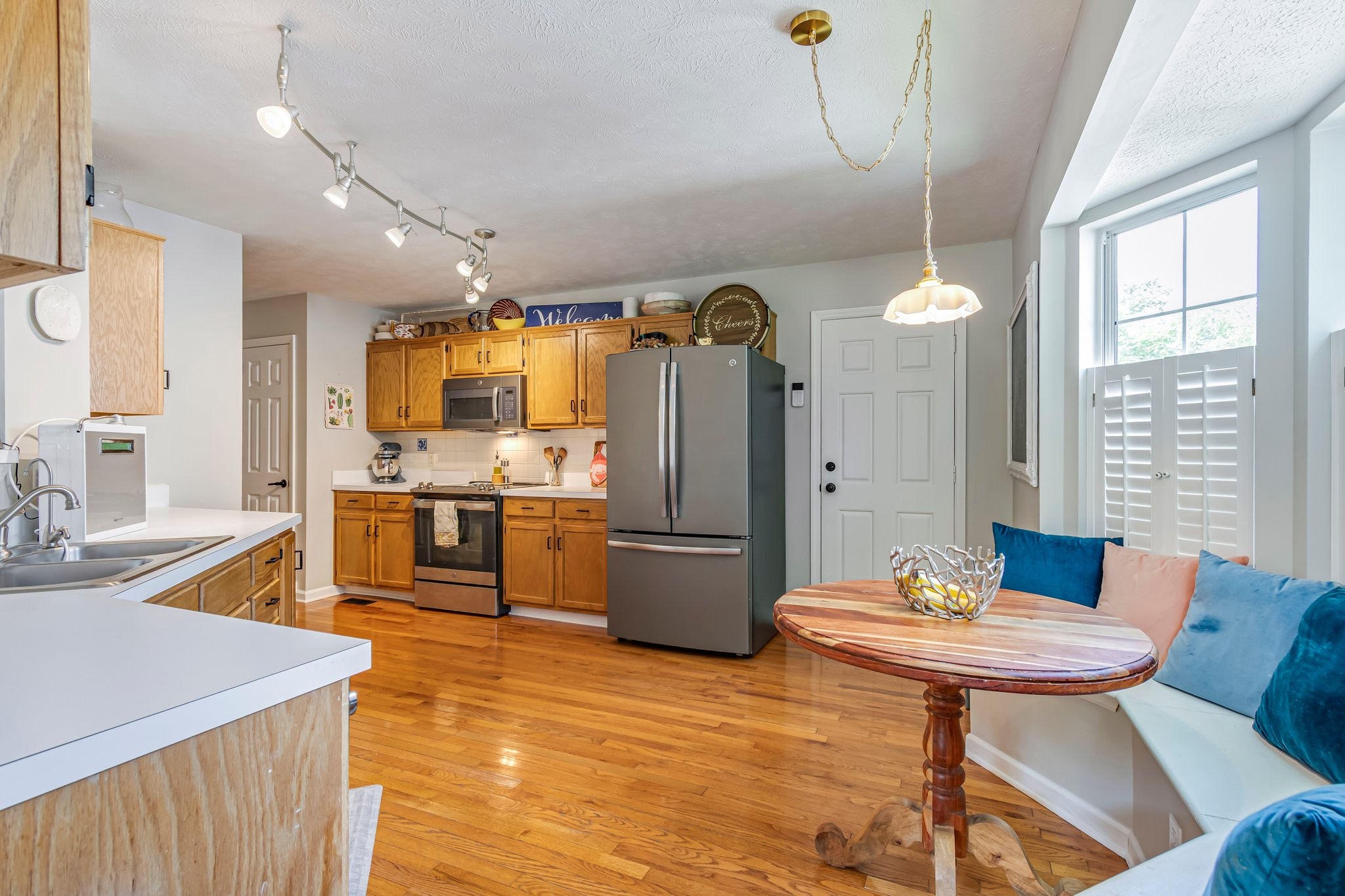1817 Bryce Circle Nashville, TN 37211 - Photo 15 of 54 a kitchen with stainless steel appliances wooden floor dining table and chairs