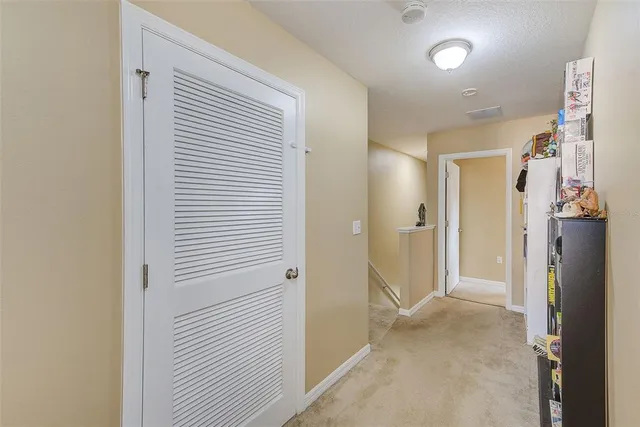 a bedroom with a bed chandelier and a window