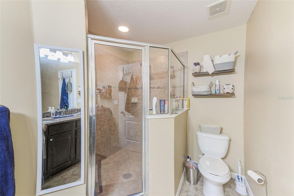 780 Spring Flowers Trail Brandon, FL 33511 - Photo 21 of 33 a bathroom with a glass shower door