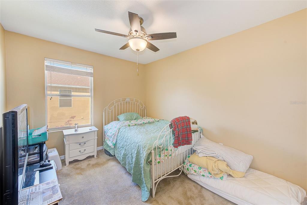 780 Spring Flowers Trail Brandon, FL 33511 - Photo 23 of 33 a bedroom with a bed and a chandelier