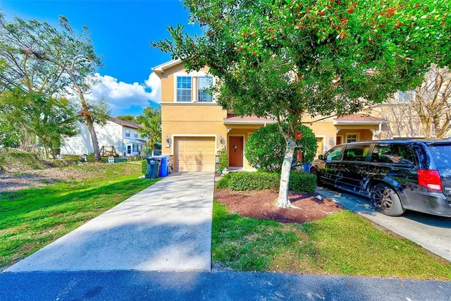 a view of a patio with couple of chairs and a yard