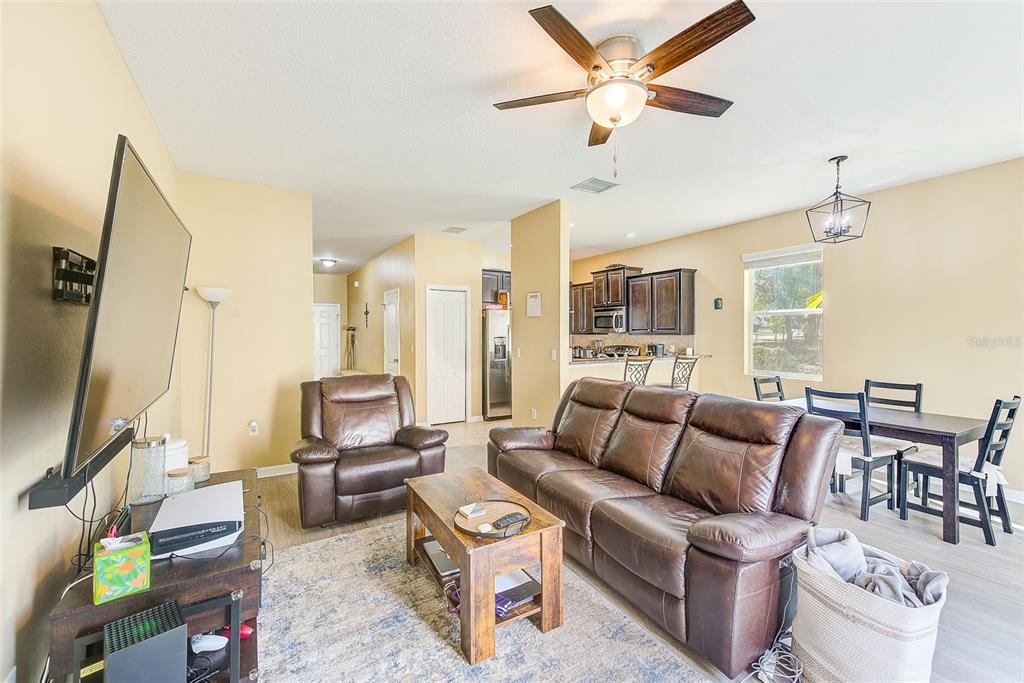 780 Spring Flowers Trail Brandon, FL 33511 - Photo 6 of 33 a living room with furniture a flat screen tv and a large window