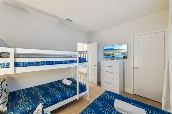a bedroom with a bed and a mirror