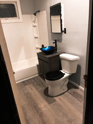 a white toilet sitting next to a sink