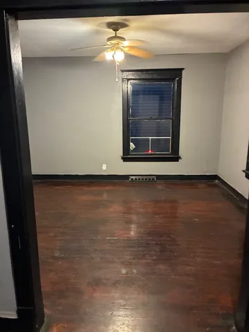 a view of wooden door a fireplace and a window