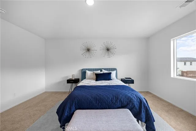 a bedroom with a bed and window