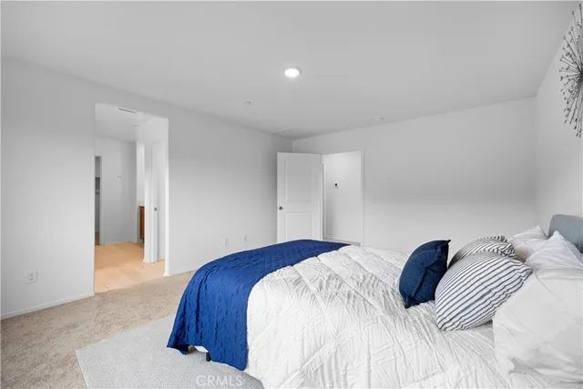 a bedroom with a bed and a painting on the wall