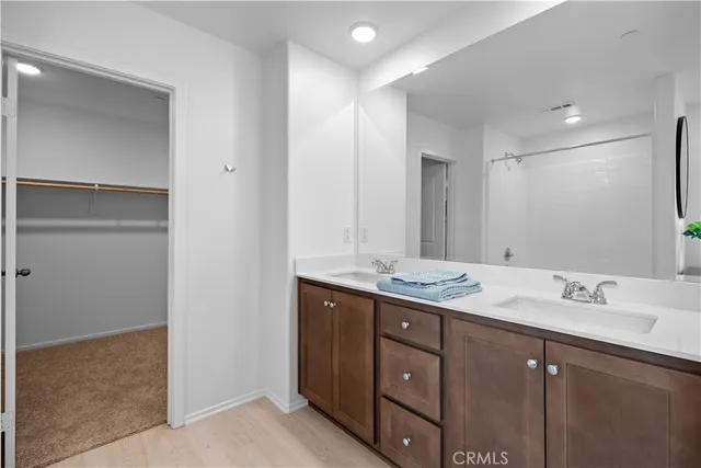 a bathroom with a sink double vanity and a mirror