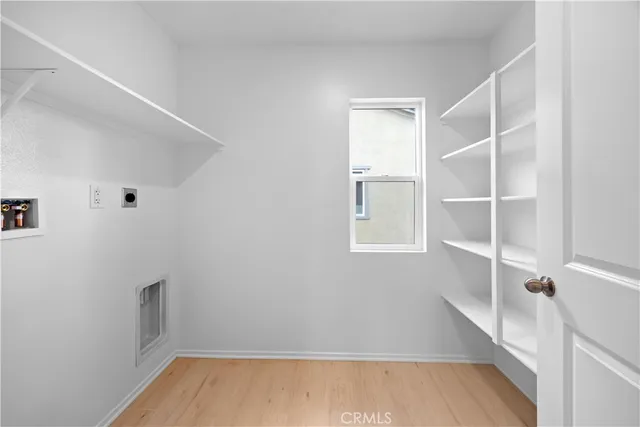 a view of walk in closet with empty racks