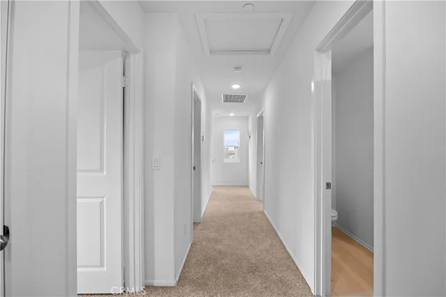a view of a hallway with a wooden floor
