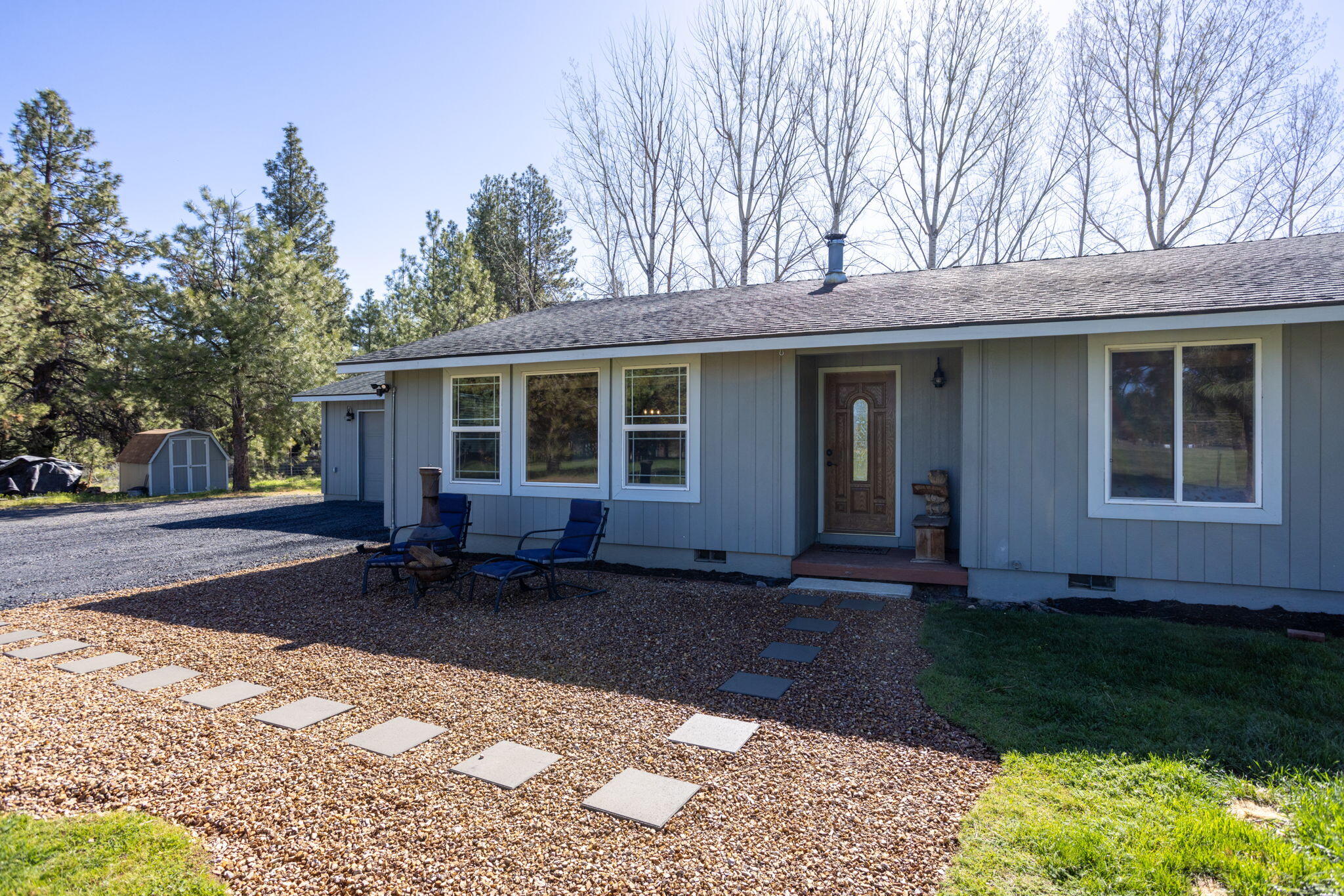 19450 Calico Road Bend, OR 97702 - Photo 6 of 41 a front view of a house with a garden and yard
