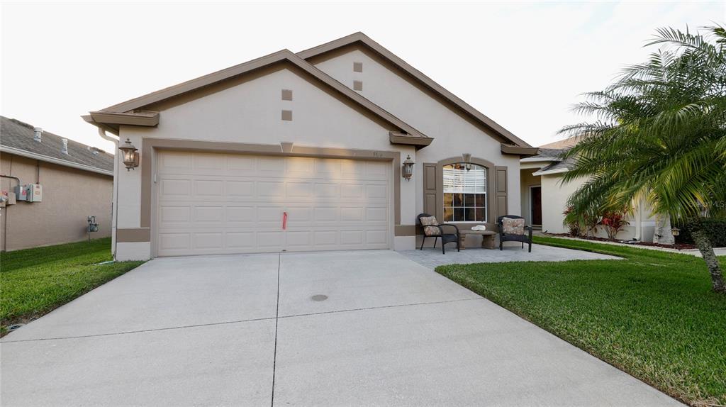3519 Hunting Creek Loop New Port Richey, FL 34655 - Photo 1 of 1 a front view of house with yard and outdoor seating