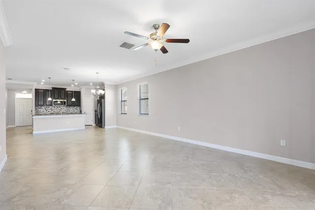 a view of an empty room with a kitchen