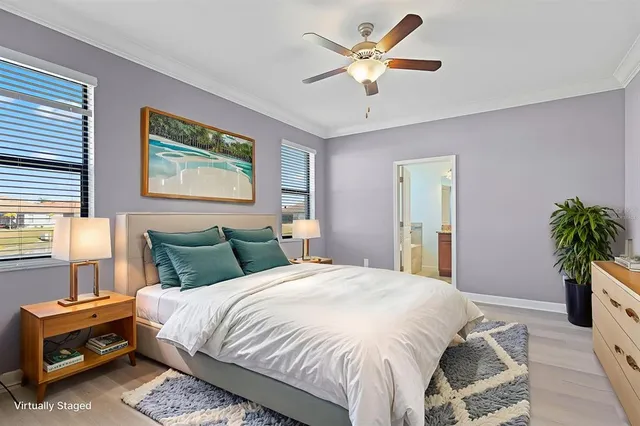 a bedroom with a bed and a potted plant