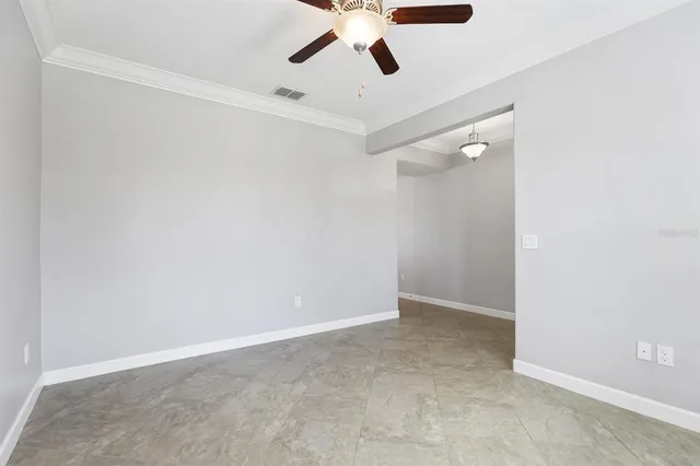 an empty room with ceiling fan