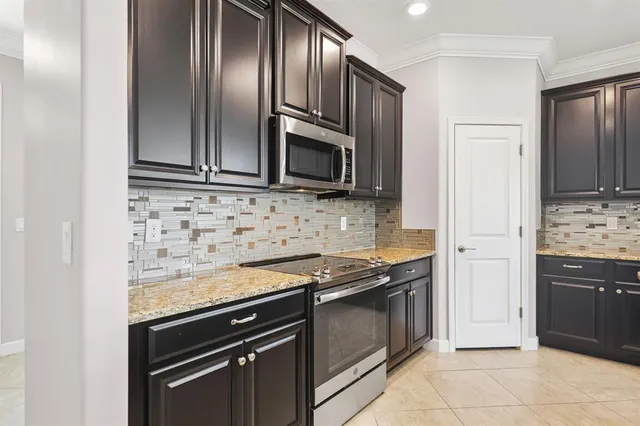 a kitchen with granite countertop stainless steel appliances and wooden cabinets