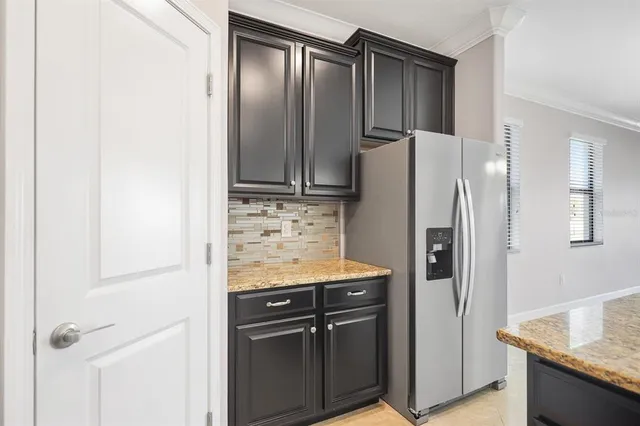a kitchen with stainless steel appliances granite countertop a refrigerator and a sink