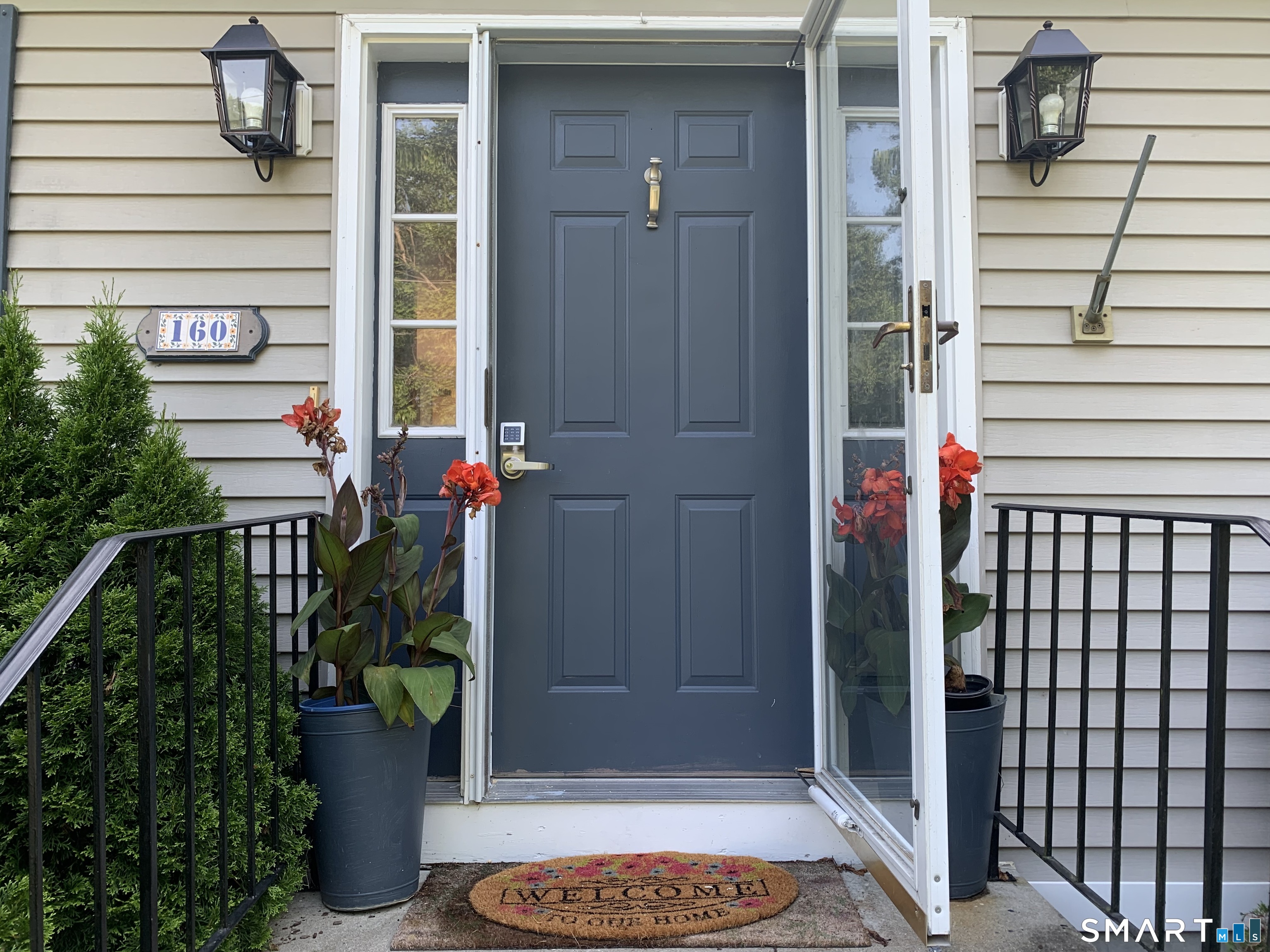160 Russell Street Groton, CT 06355 - Photo 2 of 7 a potted plant sitting in front of a door