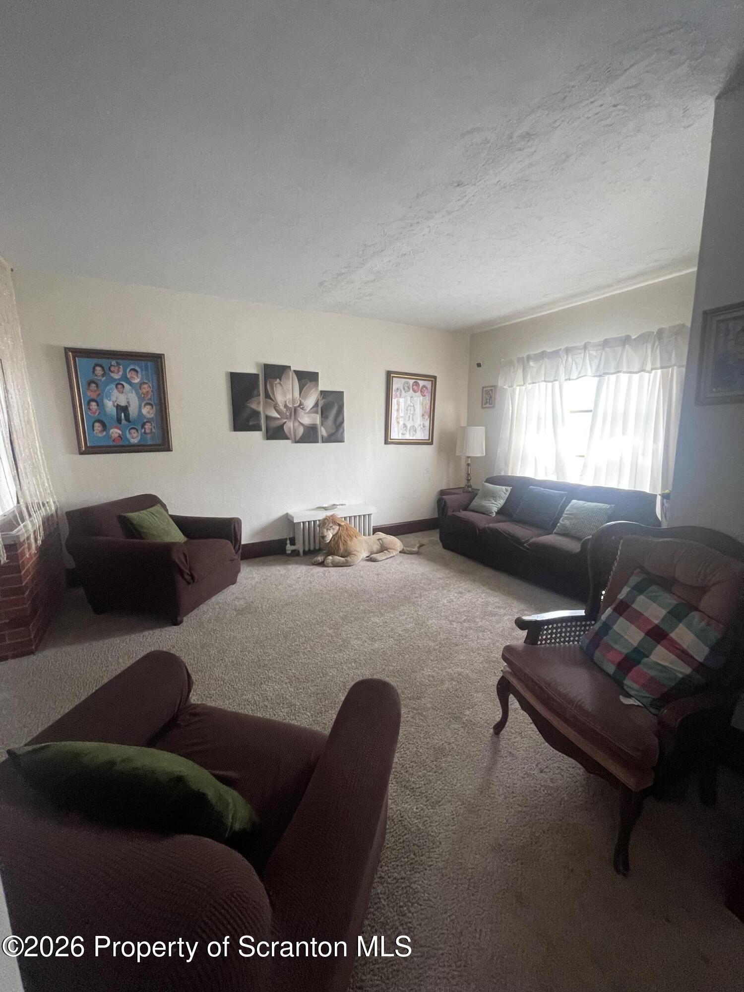 812 Willow Street Scranton, PA 18505 - Photo 11 of 19 a living room with furniture potted plant and a window