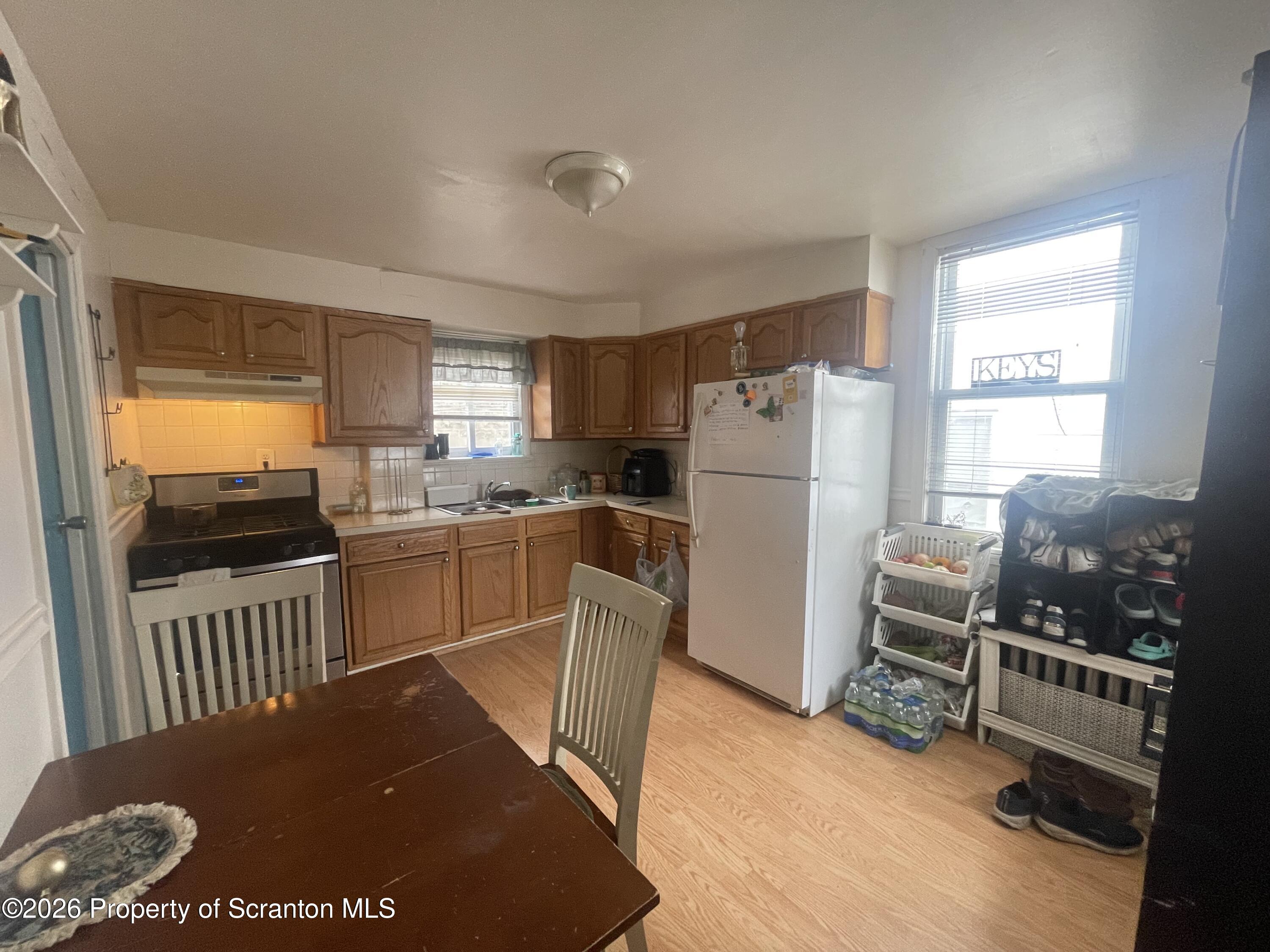 812 Willow Street Scranton, PA 18505 - Photo 14 of 19 a kitchen with a refrigerator and a stove top oven