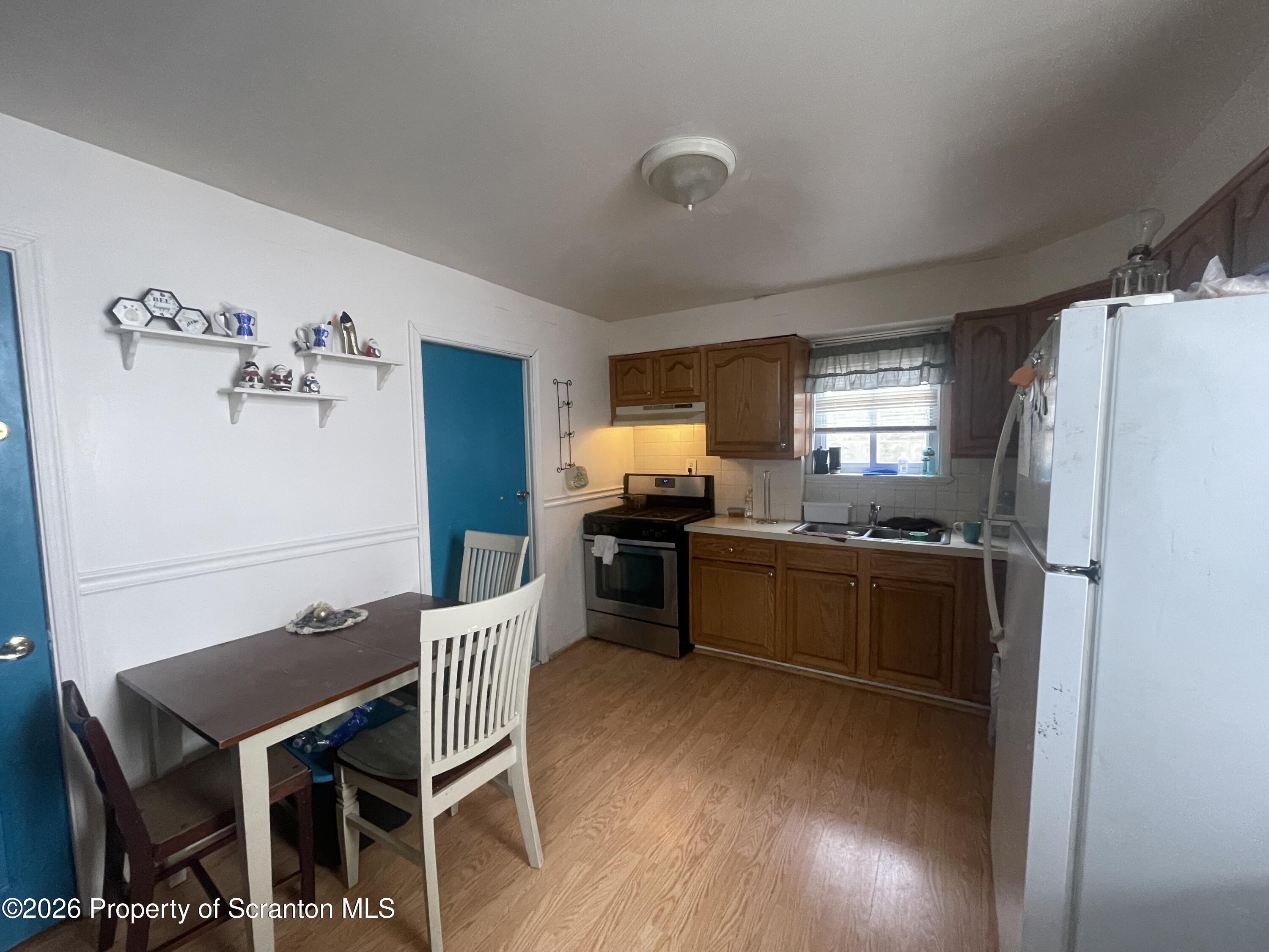 812 Willow Street Scranton, PA 18505 - Photo 15 of 19 a kitchen with a refrigerator and a table