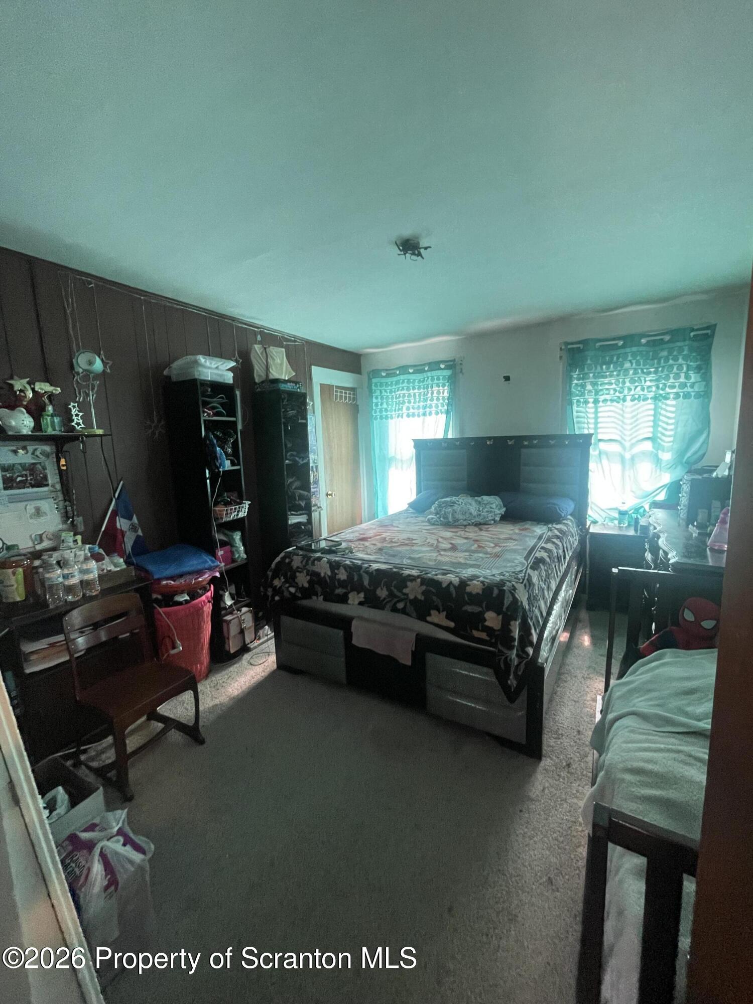 812 Willow Street Scranton, PA 18505 - Photo 18 of 19 a bedroom with a bed gym equipment and windows