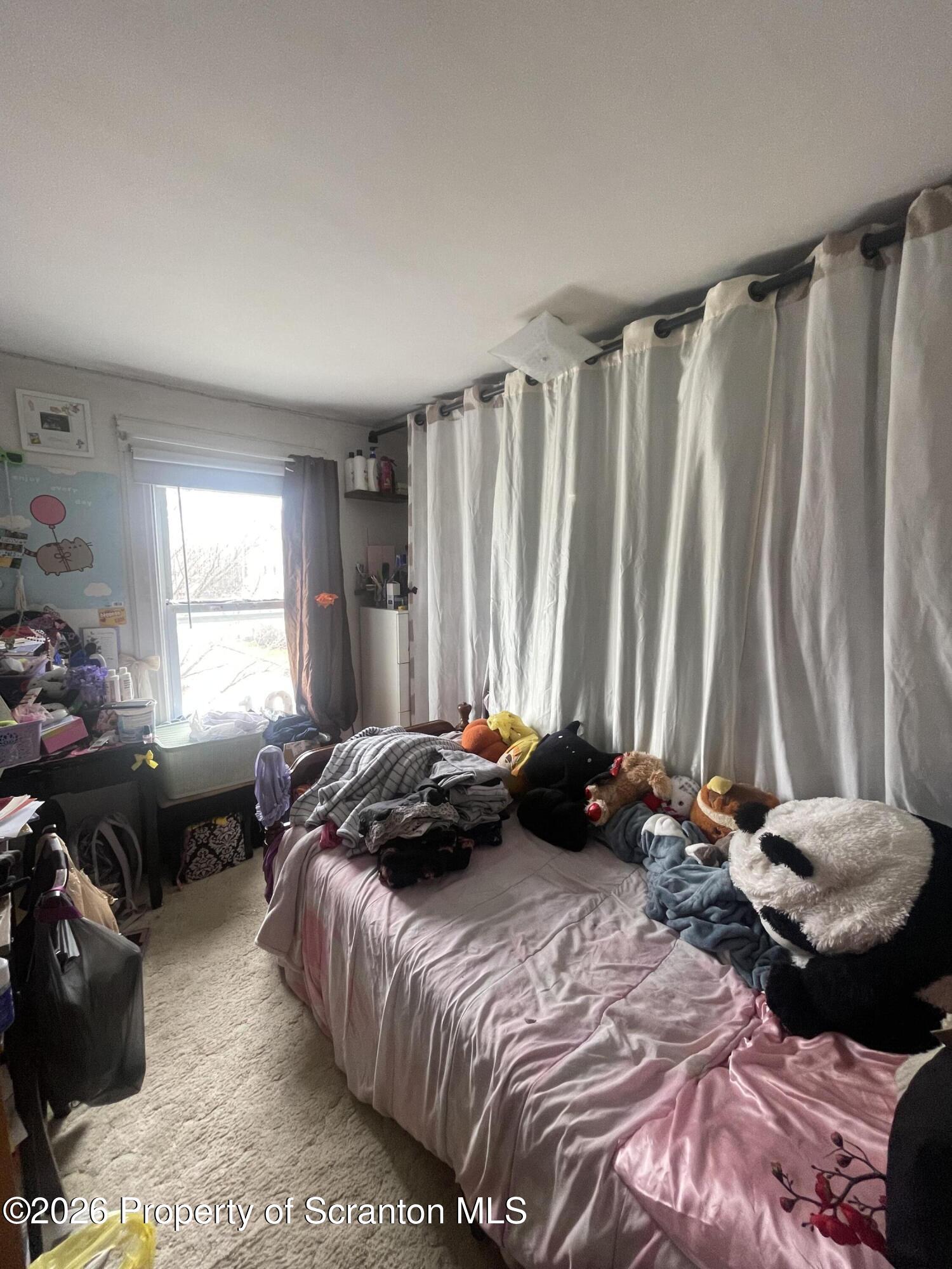 812 Willow Street Scranton, PA 18505 - Photo 19 of 19 a bedroom with a bed and a chair