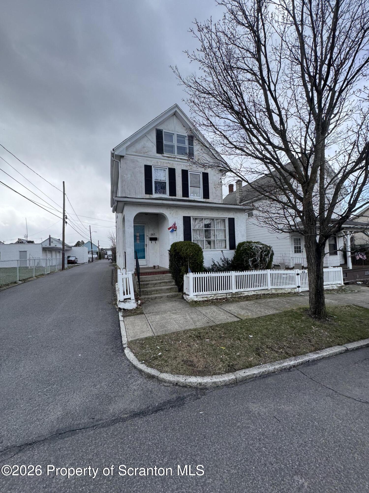 812 Willow Street Scranton, PA 18505 - Photo 2 of 19 a view of a white house next to a road and trees