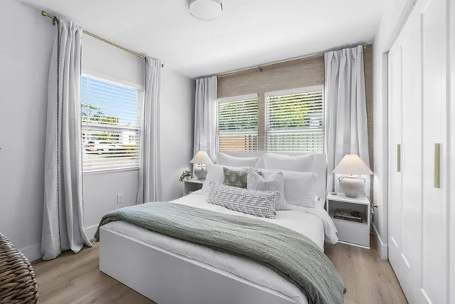 a bedroom with a bed and a window