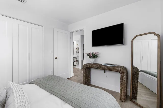 a bedroom with a bed and a flat screen tv