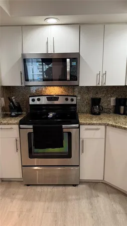 a kitchen with a stove and a microwave
