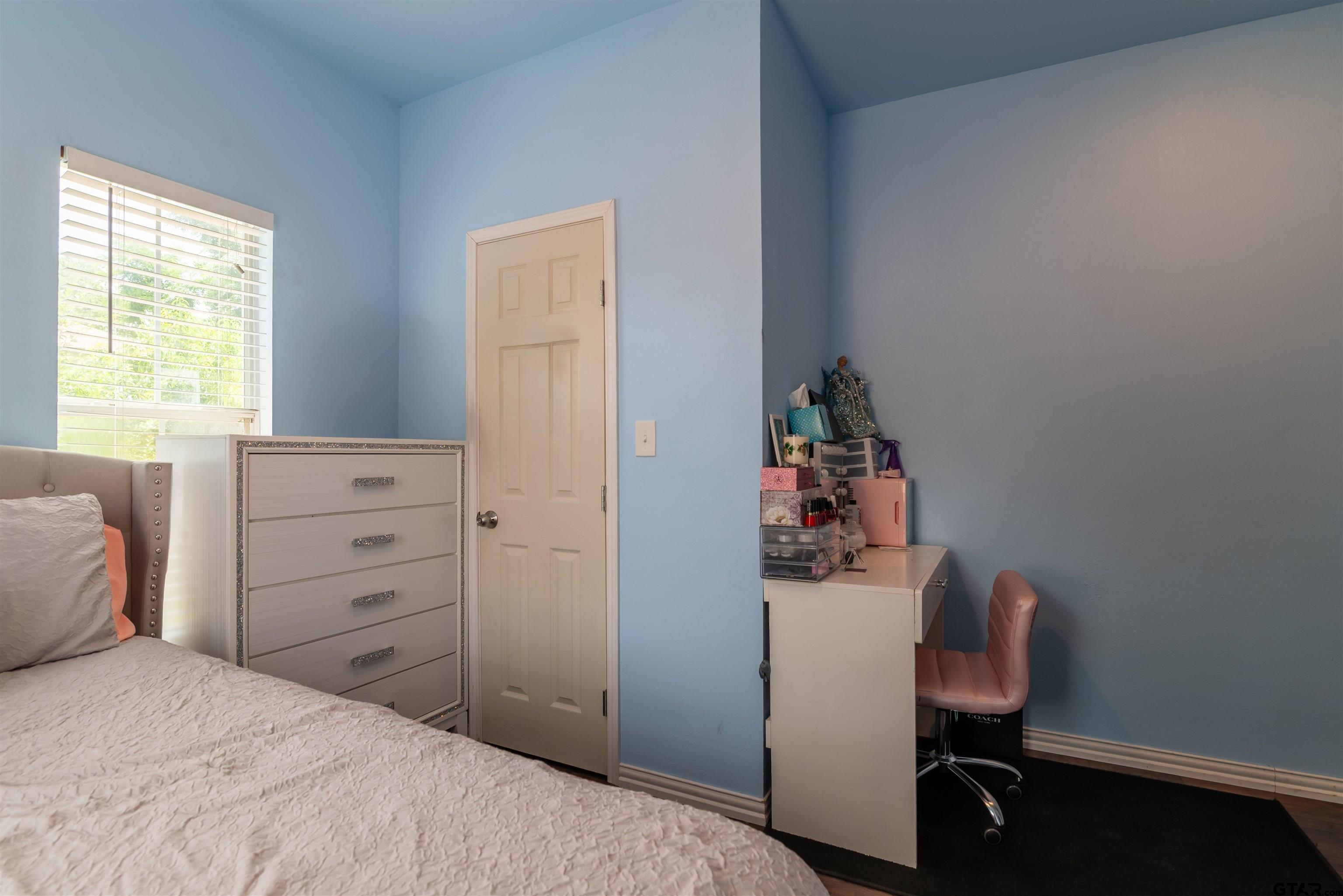 427 East Locust Street Tyler, TX 75702 - Photo 22 of 42 a bedroom with a bed and a chair