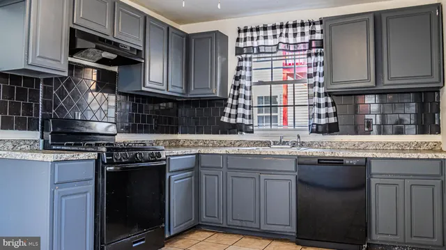 a kitchen with stainless steel appliances granite countertop a stove and a sink
