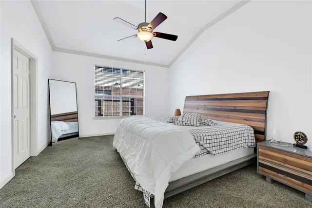 a bedroom with a bed closet and a ceiling fan