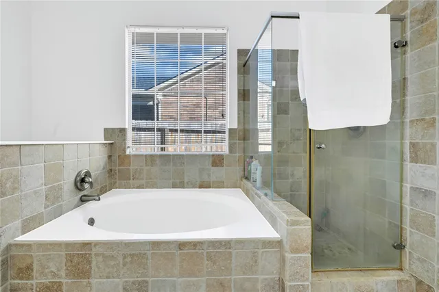 a bathroom with a bathtub and shower